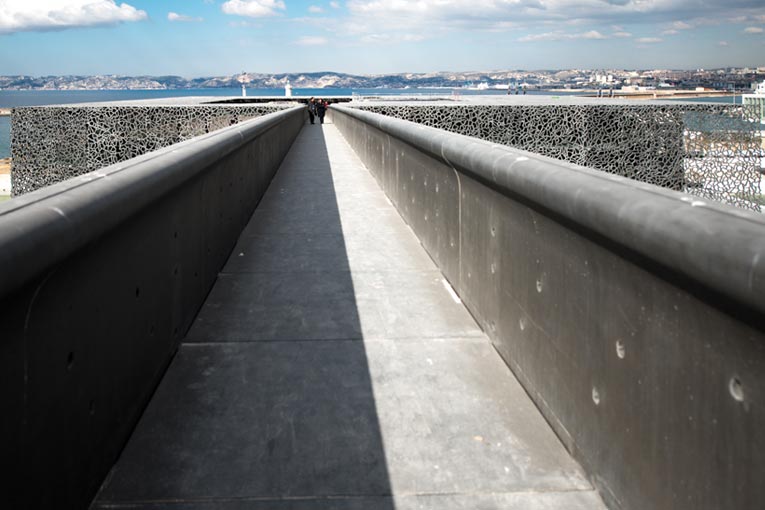 Le Bfup permet d’utiliser une bien moindre quantité de matériau, tout en offrant les mêmes performances qu’un béton classique. Passerelle en Bfup menant au Mucem, s’articulant autour d’une structure en Bfup et habillée d’une résille en Bfup. Rudy Ricciotti, architecte. [©ACPresse]